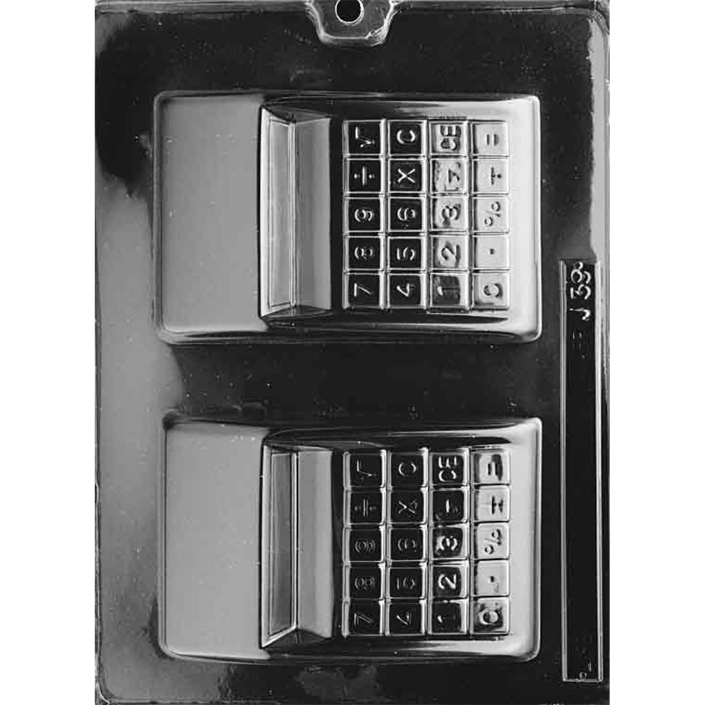 Clear plastic chocolate mold with two calculator-shaped cavities, each featuring a raised keypad with numbers and symbols and a rectangular display screen, shown on a dark background.
