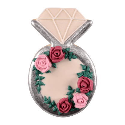 Diamond ring-shaped cookie decorated with a silver metallic border and delicate pink roses with green leaves.