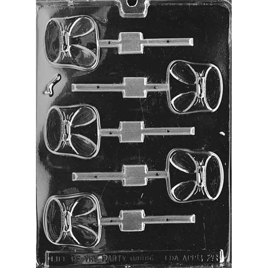 Clear plastic chocolate lollipop mold with six diaper-shaped cavities, each showing embossed fold lines and tab detail with a stick channel, on a dark background.