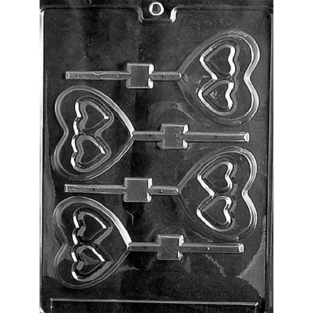 Black plastic chocolate lollipop mold with four large heart-shaped cavities, each featuring two smaller hearts inside, with stick channels for making heart chocolate pops.
