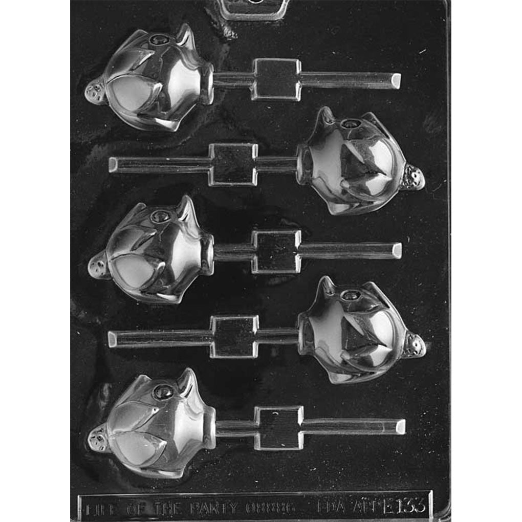 Clear plastic chocolate lollipop mold with six duckling head cavities featuring a raised eye, rounded bill, and a small hat on top, each connected to a straight stick channel on a dark background.