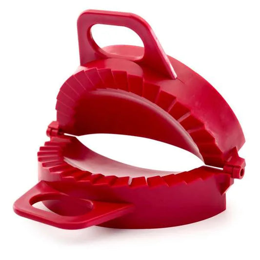 Red dumpling dough press shown open, with crimped edges and ergonomic handles.