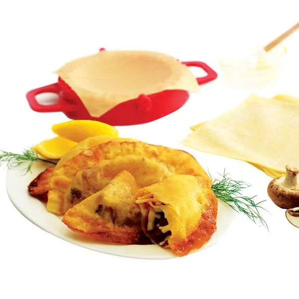 Cooked savory turnovers on a plate with press and dough shown in the background.