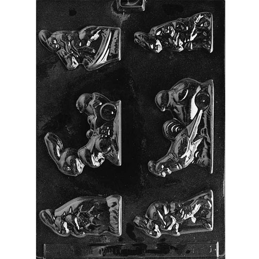 Clear plastic chocolate mold with assorted Easter scene cavities, including bunnies with eggs, bunnies pulling wagons with chicks, a bunny riding a horse, and a rooster wagon scene, on a dark background.