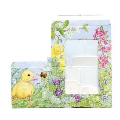 Easter candy box shown from the front with a clear window, featuring a yellow duckling and spring flowers in a watercolor illustration.