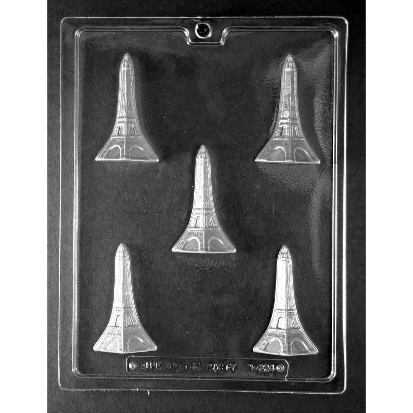 Clear chocolate mold with five small Eiffel Tower-shaped cavities arranged across a dark background.