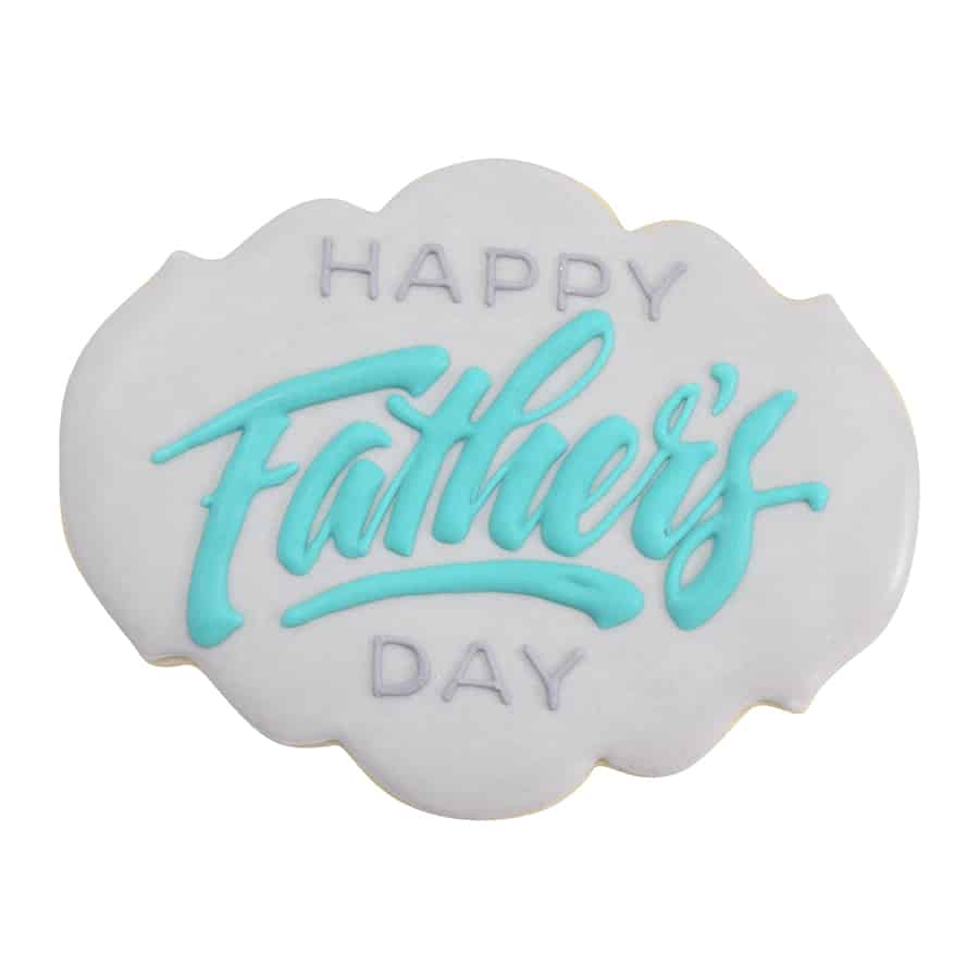 White iced cookie with "Happy Father’s Day" in blue script.