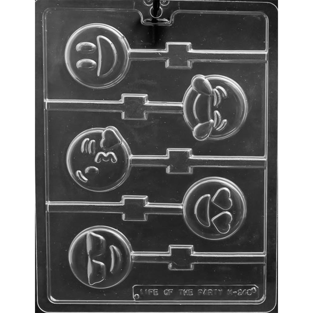 Clear chocolate lollipop mold with five round emoji face cavities on a dark background, including a smiling face, heart-eyes face, sunglasses face, winking face, and laughing face.