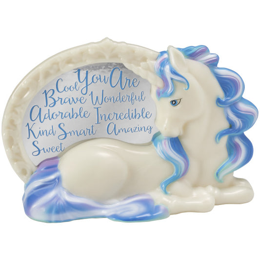 Close-up of an enchanting unicorn cake topper figurine with flowing pastel-colored mane and tail, displaying positive affirmations including "brave," "adorable," and "amazing."