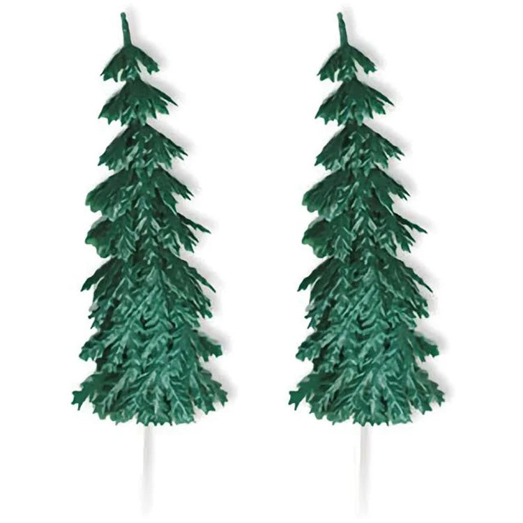 Two large green evergreen tree cake picks with layered pine branch texture and white pick stems, shown on a white background.