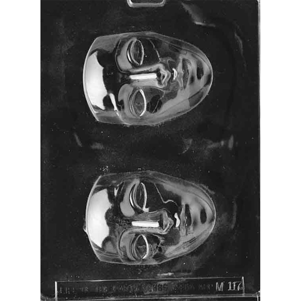Clear Face Mask Chocolate Mold photographed against a black background with two deep face-shaped cavities featuring sculpted eyes, noses, and lips.