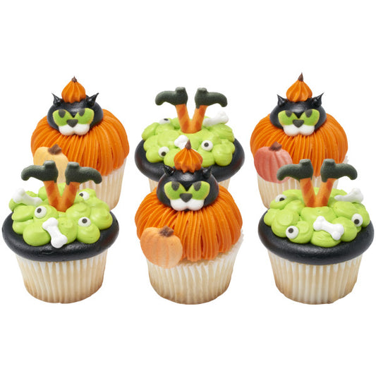 Halloween-themed cupcakes topped with green and orange frosting, spooky decorations, and shimmer pumpkin sugar toppers.