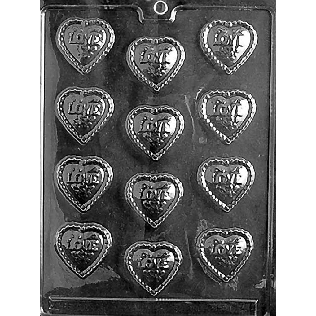 Clear chocolate mold with 12 small heart-shaped cavities, each embossed with the word Love and finished with a decorative border on a dark background.