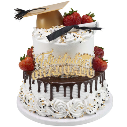 White round cake with chocolate drip and whipped frosting swirls, topped with a gold graduation cap decoration, strawberries, and a Felicidades Graduado cake topper on the front.