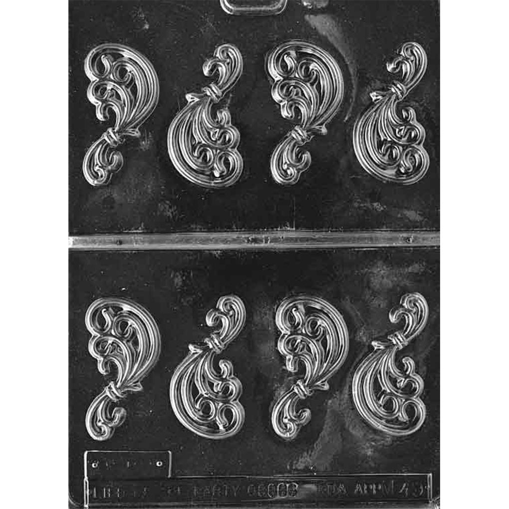 Clear plastic chocolate mold with eight ornate filigree cavities featuring swirling scrollwork patterns for making decorative chocolate pieces.