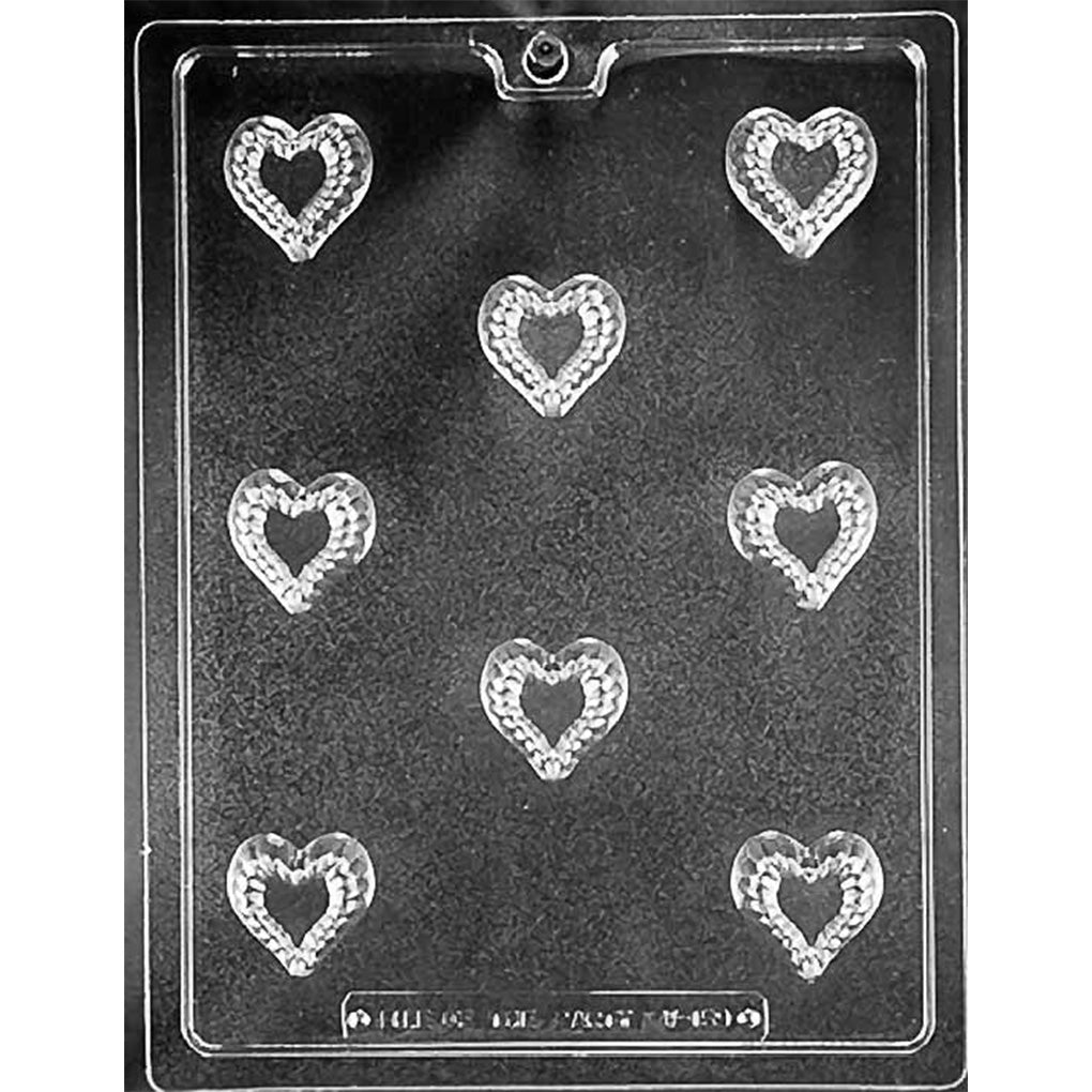 Clear chocolate mold with eight small heart-shaped cavities, each featuring a smaller heart center surrounded by a textured heart-shaped border.