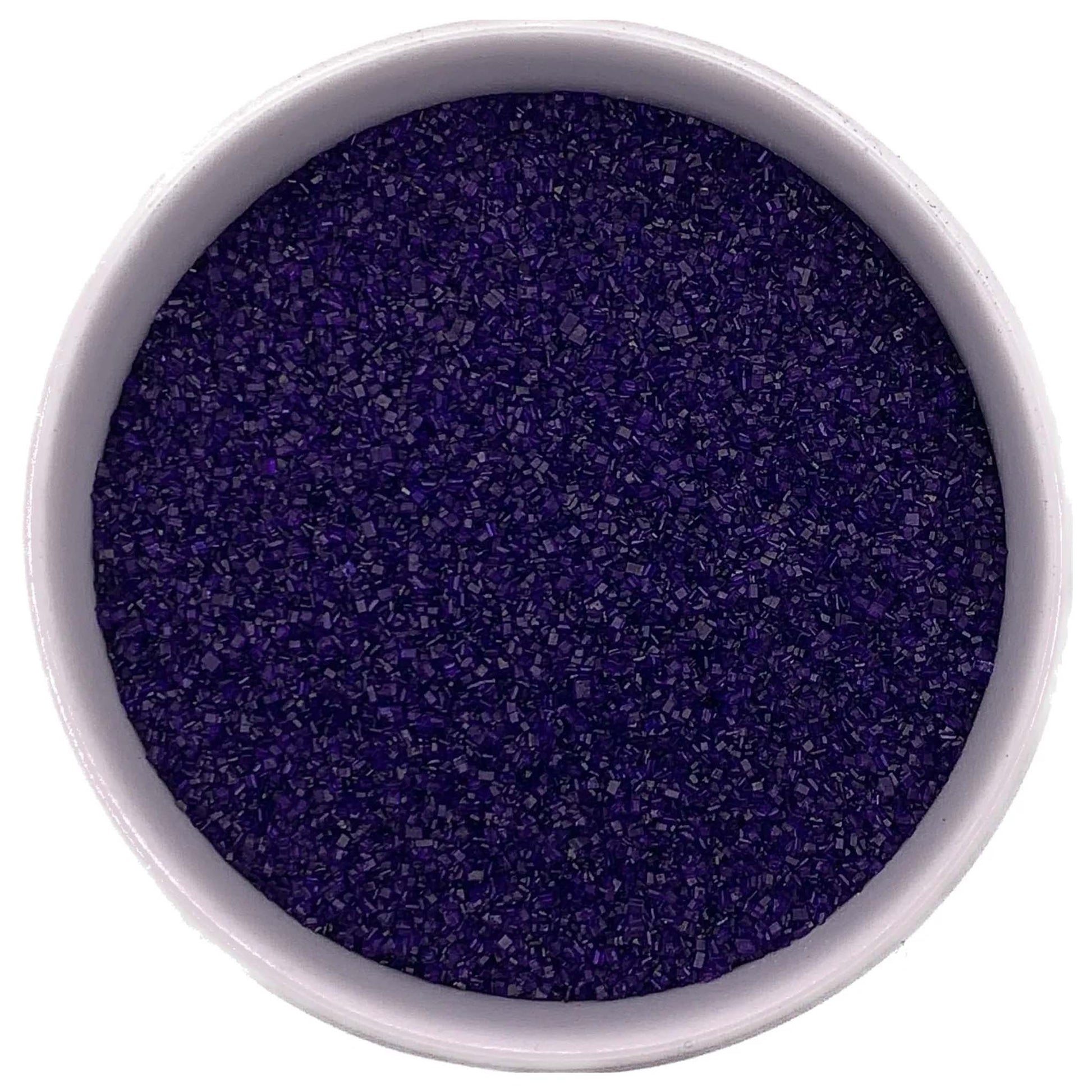 Top-down view of a white bowl filled with purple fine sanding sugar, showing tiny sparkling crystals in a deep violet-purple shade.