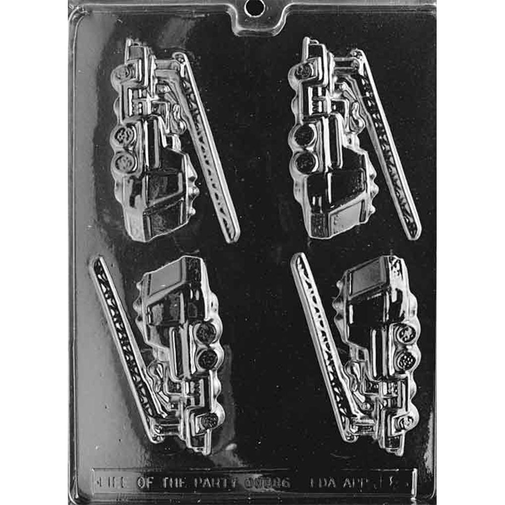 Clear chocolate mold with four detailed firetruck cavities featuring raised ladders, wheels, cab windows, hoses, and equipment panels on a dark background.