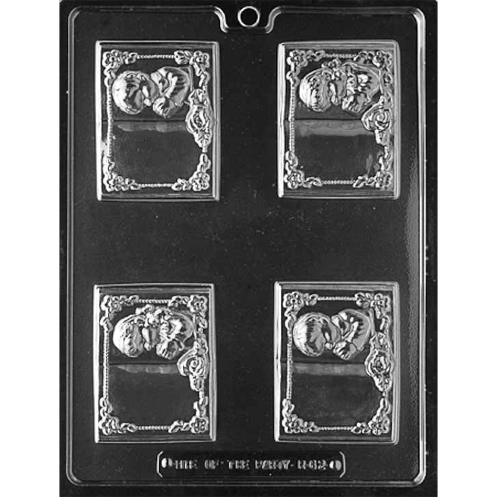 Four-cavity First Communion book chocolate mold with two praying boy and two praying girl designs, floral borders, roses, and blank message panels.