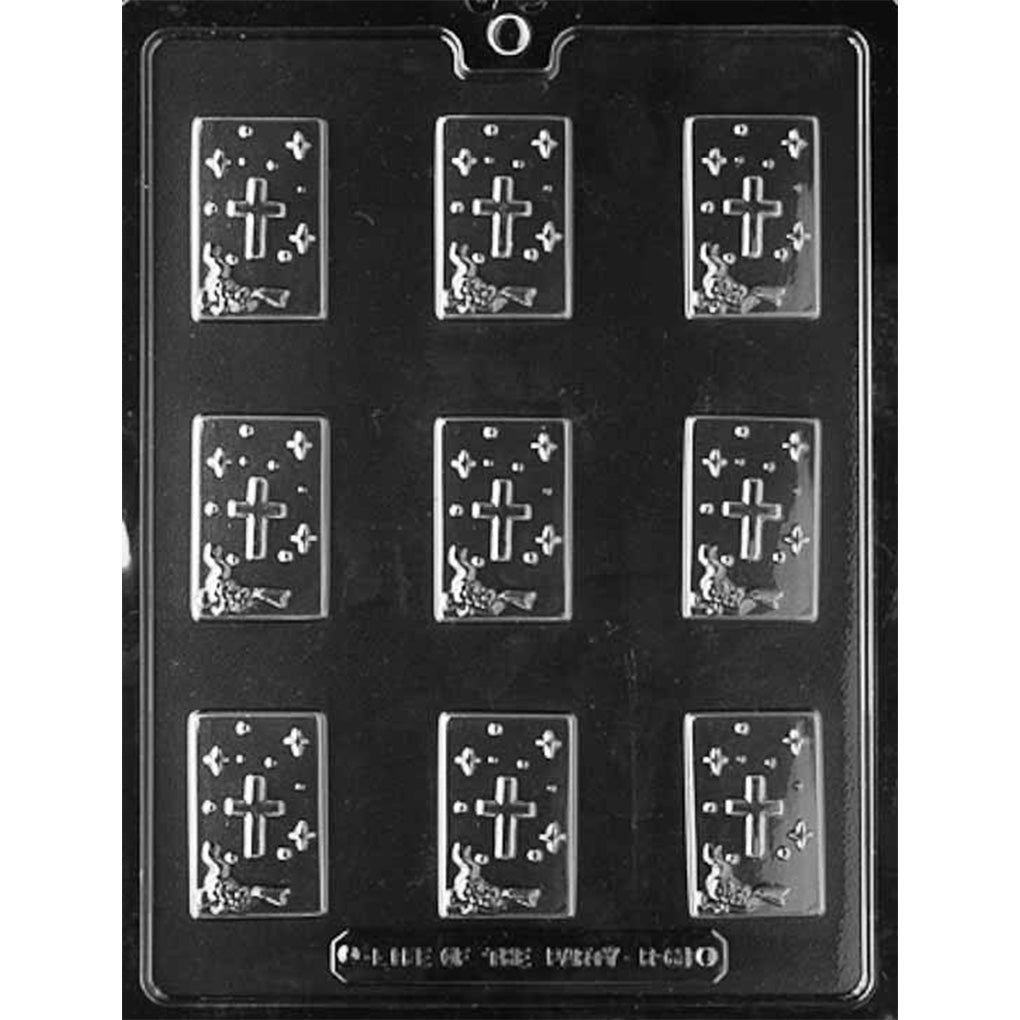 Clear plastic chocolate mold with nine small rectangular cavities featuring a cross and star design, arranged in three rows on a dark background.