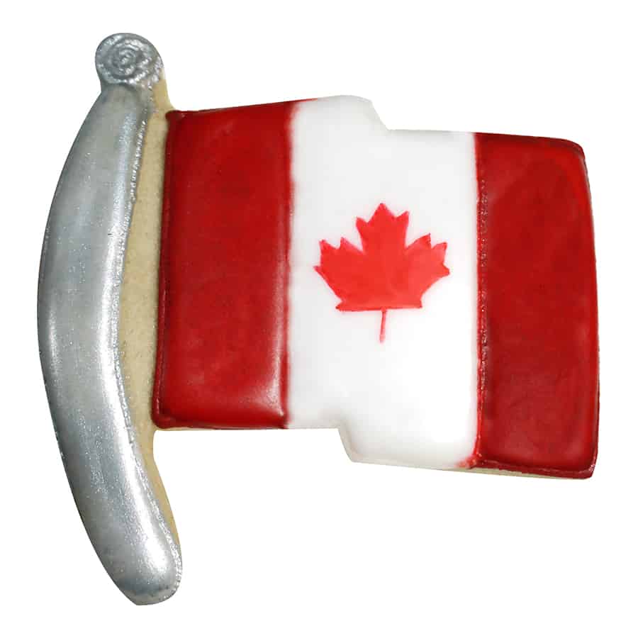 Flag-shaped cookie decorated as the Canadian flag with red and white icing and a maple leaf design.