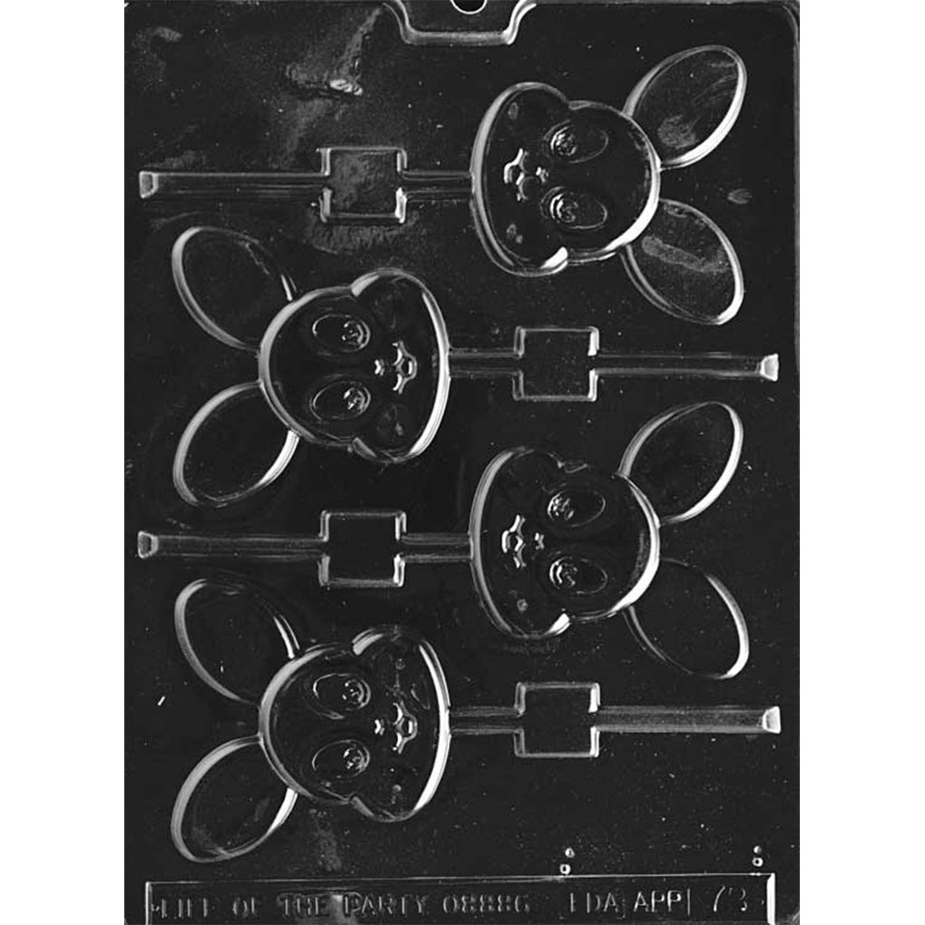 Flat baby bunny face chocolate lollipop mold with four cavities on a dark plastic tray, each showing a round bunny face with chubby cheeks, big eyes, and oversized ears with stick channels.