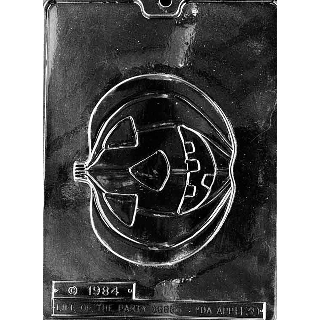 Single-cavity carved pumpkin chocolate mold measuring 4 3/4 x 5 3/4 inches with triangular eyes, nose, toothy grin, stem, and curved pumpkin grooves