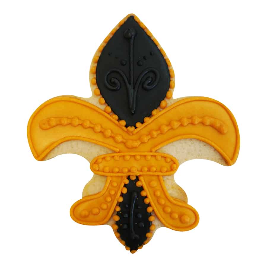 Fleur De Lis-shaped sugar cookie decorated with black and gold icing, featuring intricate piped details and a royal-inspired design.