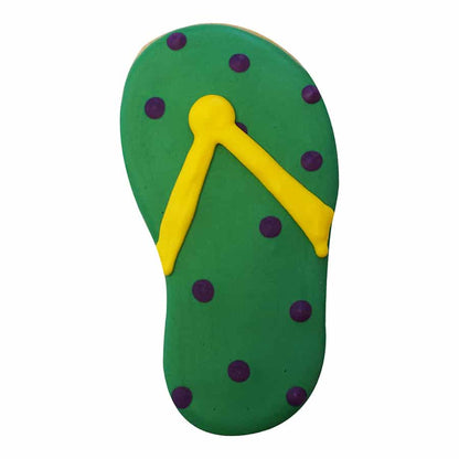 Decorated flip flop cookie with green icing, yellow straps, and purple polka dots.