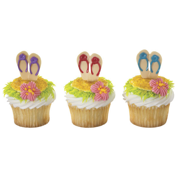 Decorated summer cupcakes topped with colorful flip flop picks and piped icing flowers.