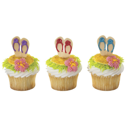 Decorated summer cupcakes topped with colorful flip flop picks and piped icing flowers.
