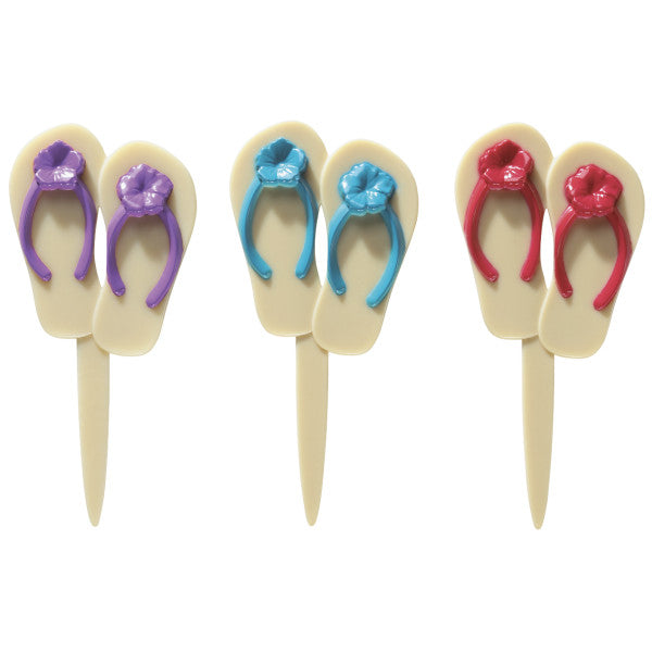 Assorted plastic flip flop cupcake picks in red, purple, and turquoise with floral accents, arranged in a row.