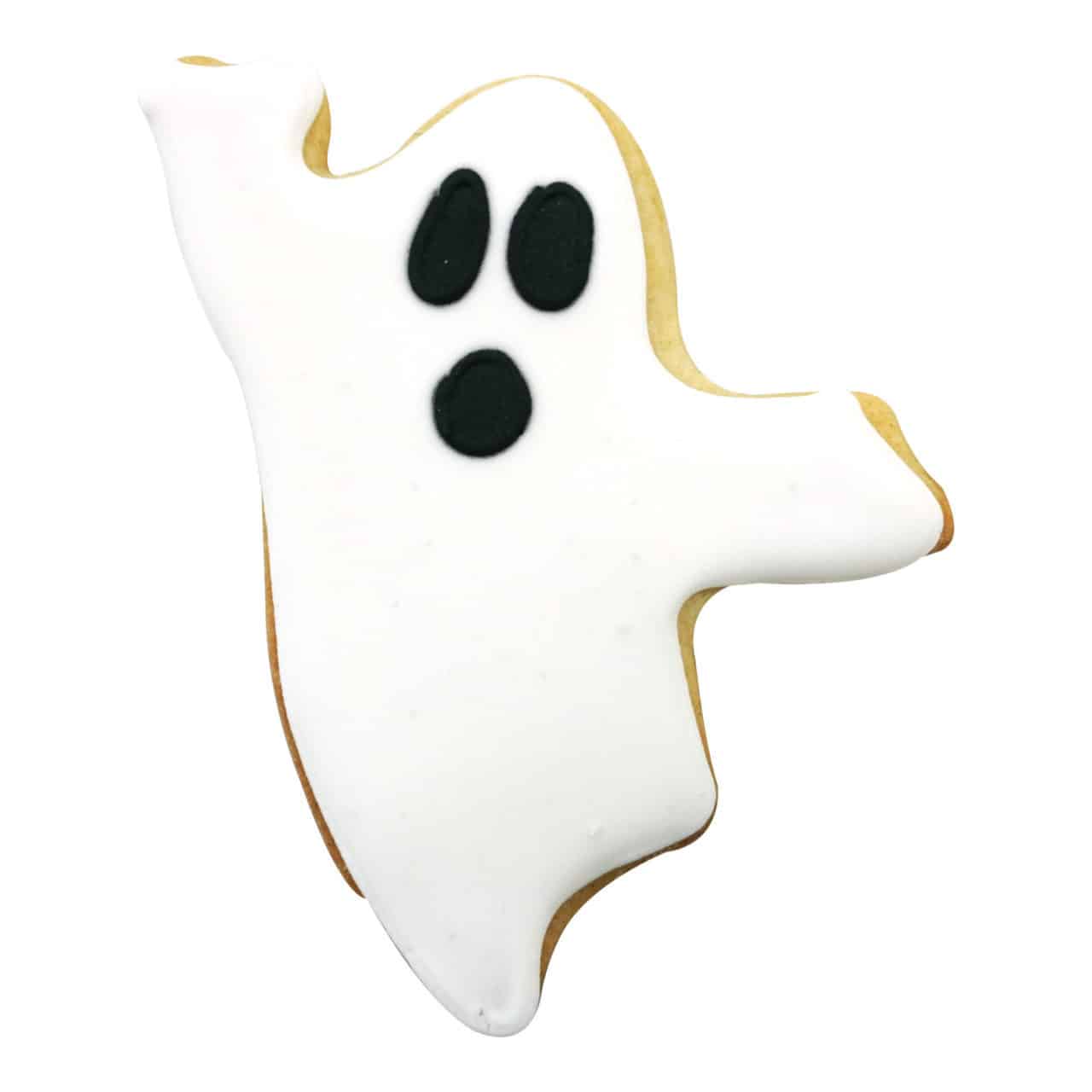 Ghost-shaped cookie decorated with white icing and black eyes and mouth for a spooky Halloween look.