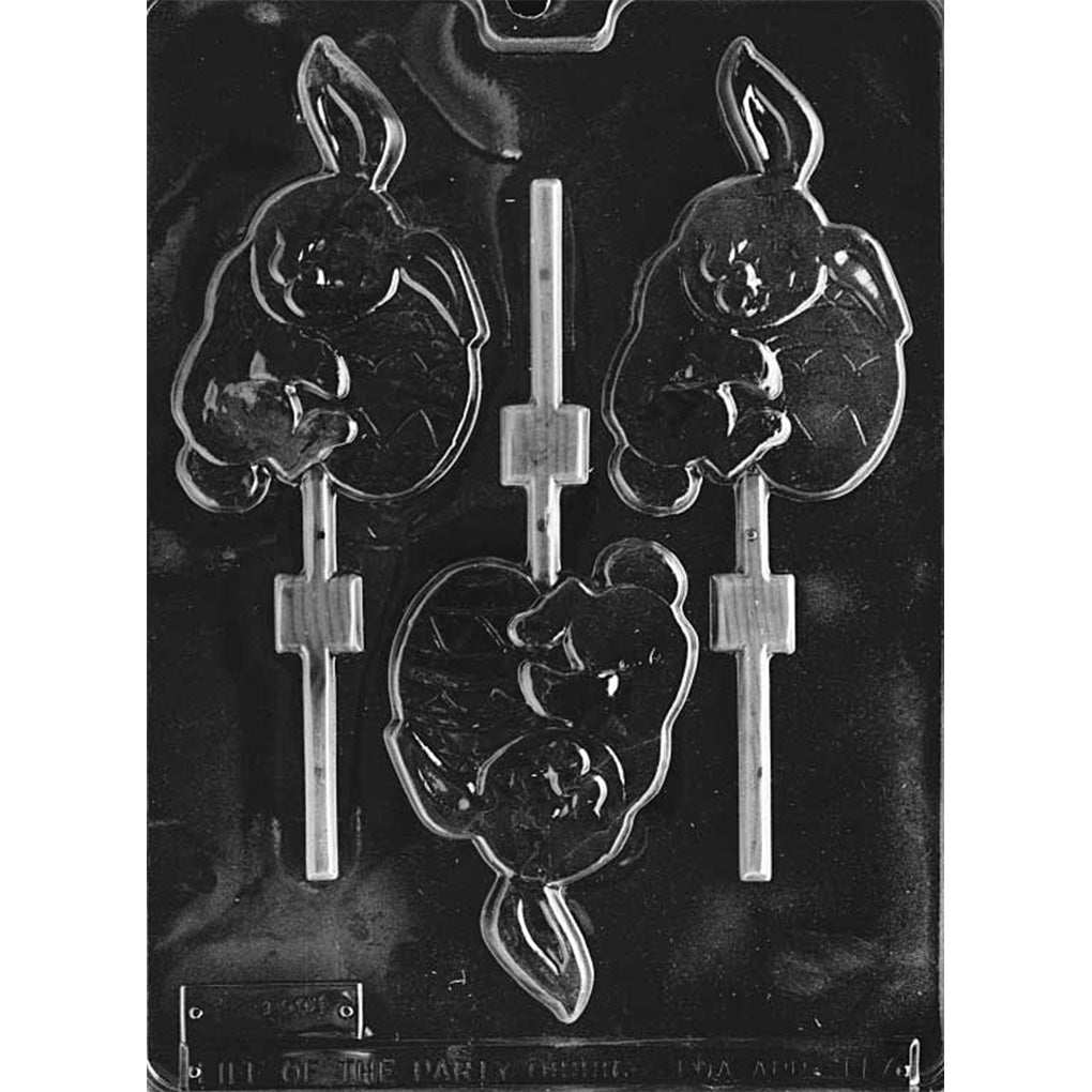 Clear plastic chocolate lollipop mold with three cavities showing a floppy-eared bunny hugging a large Easter egg, with recessed channels for lollipop sticks.