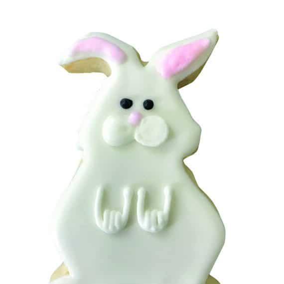 Decorated bunny-shaped cookie with white icing, pink ears, and cute facial details.