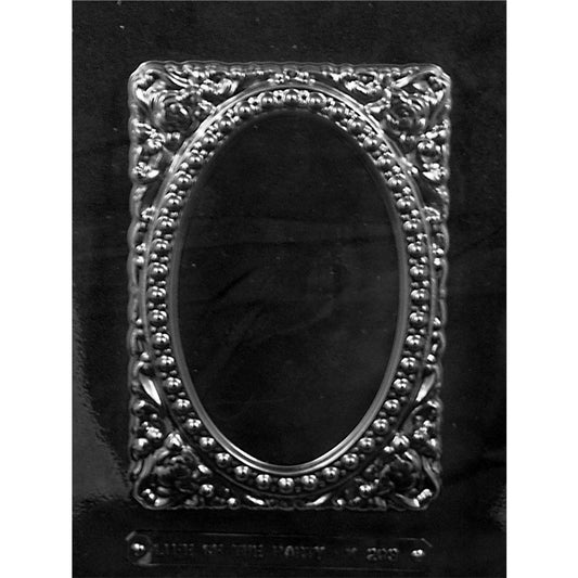 Clear plastic chocolate mold with one large ornate rectangular frame cavity featuring floral corners and an oval center.
