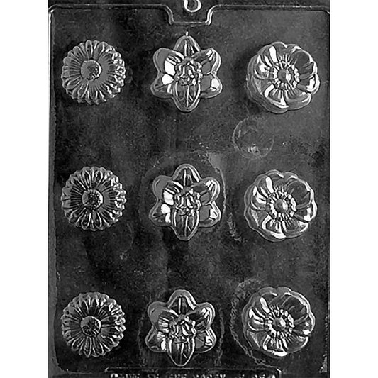 Clear plastic chocolate mold with nine flower-shaped cavities in three designs, including a daisy-style flower, an orchid-style flower, and a rounded layered blossom.