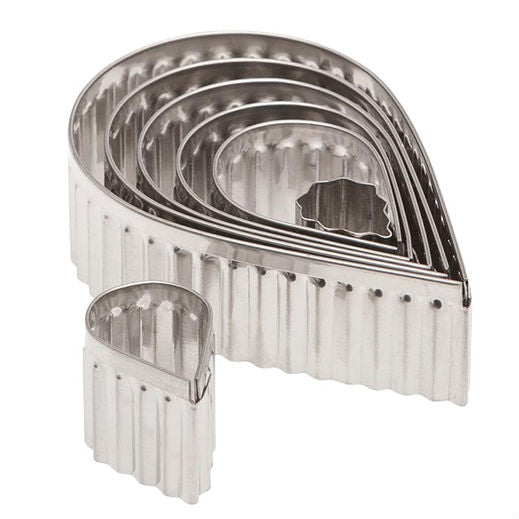 Set of seven stainless steel fluted teardrop-shaped cookie cutters, neatly nested together in descending size order.