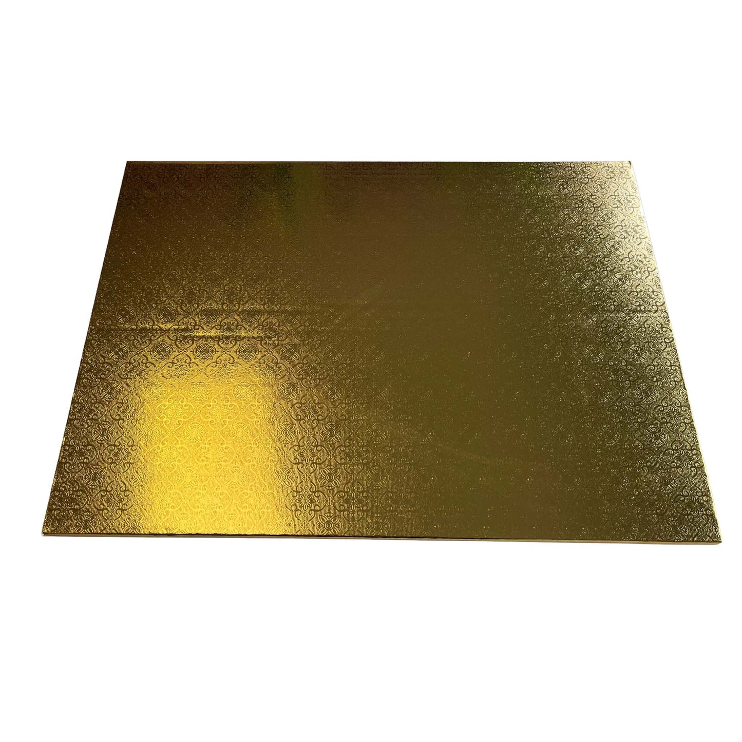Gold foil covered quarter sheet cake board with an embossed decorative pattern, photographed at an angle on a white background.
