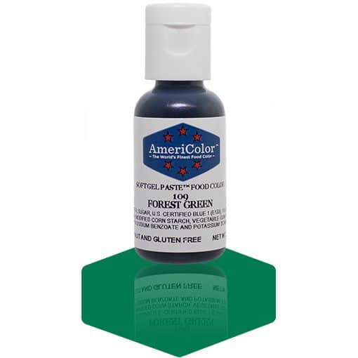 A bottle of AmeriColor Forest Green soft gel paste food coloring, featuring a white cap and blue label with red stars, standing on a glossy green surface with a mirrored reflection of the bottle.