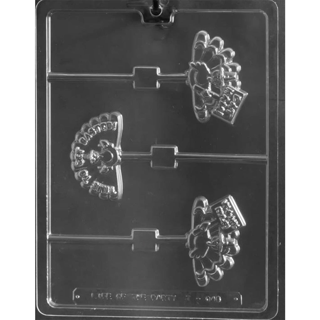 Clear plastic chocolate mold photographed on a dark background with three turkey-shaped cavities; each turkey wears a pilgrim hat and holds a small sign with a humorous saying.