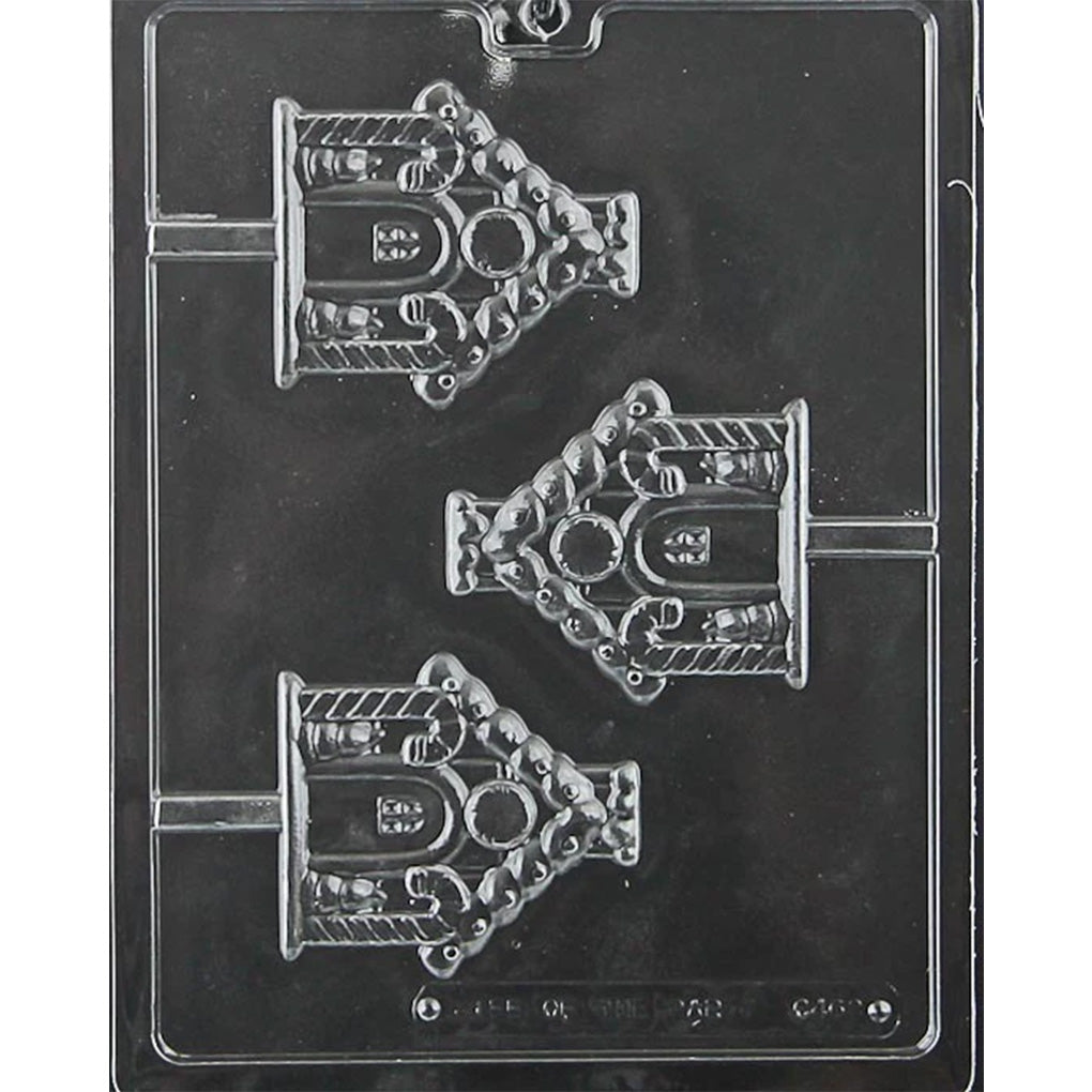 Clear plastic gingerbread house chocolate lollipop mold photographed on a black background, showing three house-shaped cavities with roof, door, window, and candy-style decorative details.