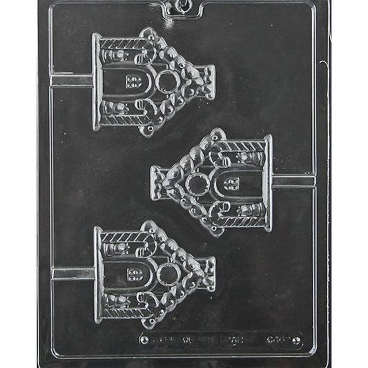 Clear plastic gingerbread house chocolate lollipop mold photographed on a black background, showing three house-shaped cavities with roof, door, window, and candy-style decorative details.