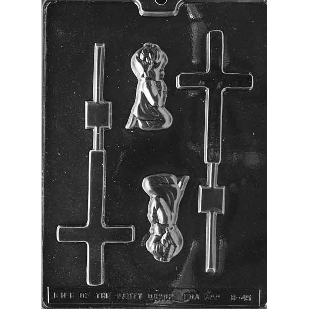 Clear plastic christening chocolate mold photographed on a black background, featuring two cross-shaped lollipop cavities with stick grooves and two kneeling praying girl figure cavities with raised details.