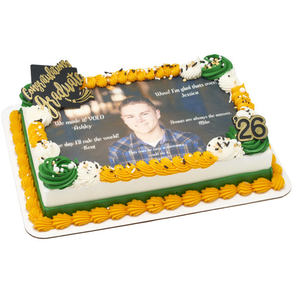 Rectangular photo graduation cake with green and yellow icing, “Congratulations Graduate” topper, and number 26 decoration.