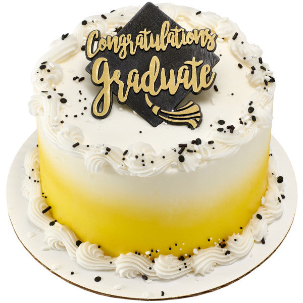 White and yellow ombre cake with black cap topper and gold “Congratulations Graduate” plaque.