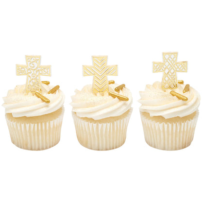 Three white cupcakes with white frosting and gold sprinkles, each topped with a different decorative gold cross cupcake pick.