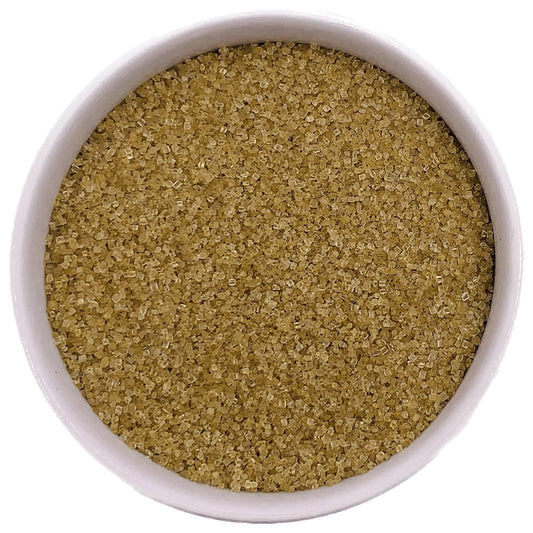 Bowl of gold fine sanding sugar crystals on a white background.