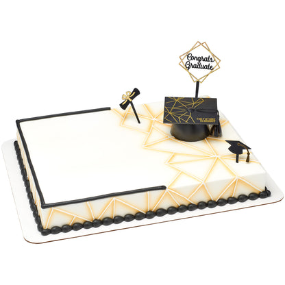 White graduation sheet cake decorated with black-and-gold cap, Congrats Graduate, diploma, and graduation cap toppers