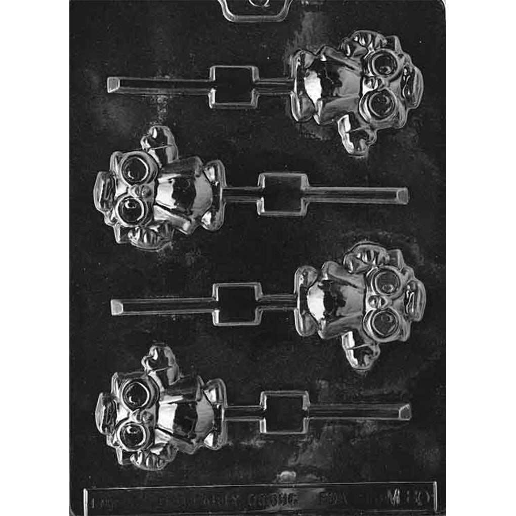 Clear plastic graduation owl chocolate lollipop mold with four owl cavities wearing mortarboard caps, featuring large round eyes, textured feathers, and stick channels on a dark background.